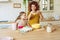 Mother and daughter prepare a cake together in the kitchen