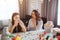 Mother and daughter prepare for Easter together. Sick girl sneezing. Young woman worry. Easter decoration with painting