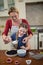 Mother and daughter preparing blue berry pie