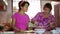 Mother daughter preparing meal together in kitchen