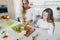 Mother daughter preparing school lunch home kitchen