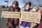 Mother and Daughter with protest signs - one says Let me guess - Iran suddenly has weapons of mass