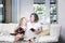 Mother and Daughter reading magical book in living room