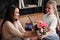 Mother and daughter relationship concept. A teenage girl congratulates happy woman on her birthday and gives her flowers