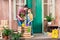 Mother and daughter removing plant and talking on porch