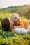 Mother with daughter rests in meadow