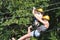 Mother and daughter riding down a zipline over the Tara Gorge, a river in Montenegro with the deepest canyon in Europe. Girls in