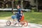 Mother and daughter riding four wheel bicycle