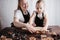 Mother and daughter rolling gingerbread dough