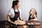 Mother and daughter rolling gingerbread dough