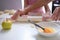 Mother and daughter rolling out flour dough at table closeup