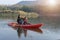 Mother and daughter rowing boat on calm waters