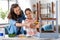 mother and daughter with ruler measuring old table