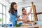 mother and daughter with ruler measuring old table