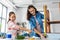 mother and daughter with ruler measuring old table