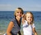 Mother with daughter at sea cost together, happy real family smiling looking to horizont, lifestyle people concept, on