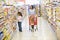 Mother and daughter shopping in supermarket