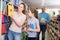 Mother with daughter shopping together in store of school stationery