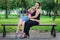 Mother and daughter sitting on a bench in the Park