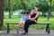 Mother and daughter sitting on a bench in the Park