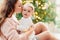 Mother and daughter sitting at Christmas tree