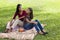 Mother and daughter sitting on picnic blanket