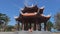 Mother and daughter sitting on steps of beautiful Buddhist building with columns