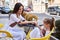 Mother and daughter sitting in street cafe summer time happy family day beautiful cute woman and small little girl in restaurant