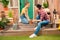 Mother and daughter sitting together on porch and cultivating plant