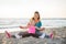 Mother and daughter sitting together stretching arms out