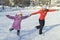 Mother and daughter skating on a skating rink