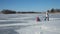 Mother and daughter sledding on frozen lake