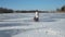 Mother and daughter sledding on frozen lake