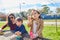 Mother daughter and son at park blowing bubbles