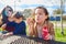 Mother daughter and son at park blowing bubbles