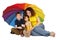 Mother, daughter and son with umbrella sitting