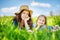 Mother and daughter on spring meadow with green grass