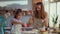 Mother and daughter sprinkling flour on table at luxury kitchen