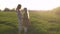 Mother and daughter standing in the green evening field