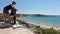 Mother and daughter standing together on viewing platform in Coral Bay beach and looking at Mediterranean seaside, Paphos, Cyprus