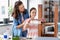 mother and daughter sticking masking tape to table