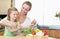 Mother and daughter stirring salad