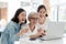 Mother and daughter surfing the internet;watching something interesting with grandmother,happy smiling asian senior woman while