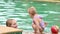 Mother and daughter swim in the pool