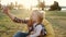 Mother and daughter take selfie on bean bag chair in a summer park on sunset