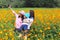 Mother and daughter taking photo in flower garden