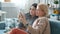 Mother and daughter taking selfie with smartphone camera posing having fun at home