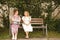 Mother and daughter talking, looking at each other on a bench in a rural place. Family members are also friends