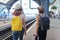 Mother and daughter teenager with backpacks suitcase walking in train station