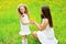 Mother and daughter together with yellow dandelion flowers